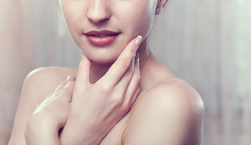 A folds her arms across her chest and cups her chin in one hand